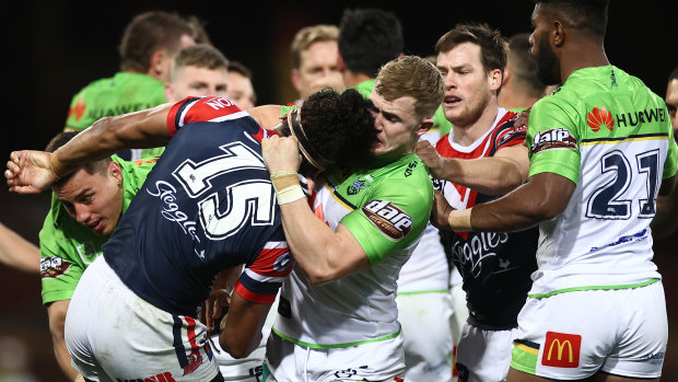Roosters and Raiders players scuffle during Canberra's win.