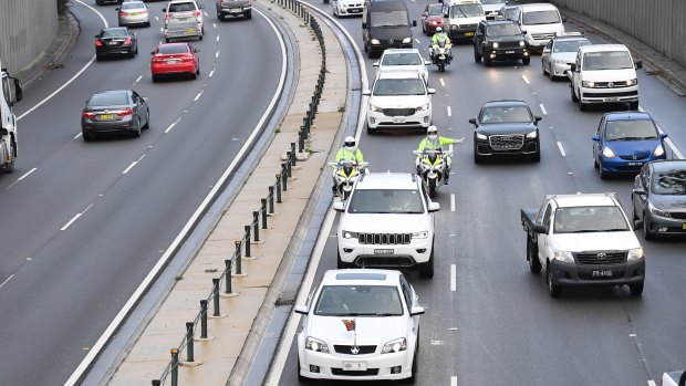 The motorcade carrying Prince Harry and Meghan Markle makes its way through peak hour traffic in Sydney.