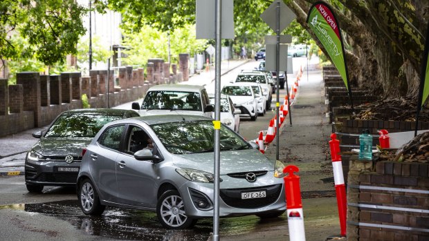 People  queue for COVID tests at a drive-through clinic in Rozelle. 