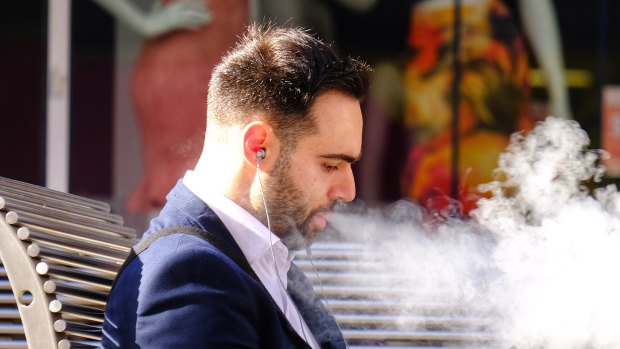 A man vaping on Bourke Street in October 2019. 