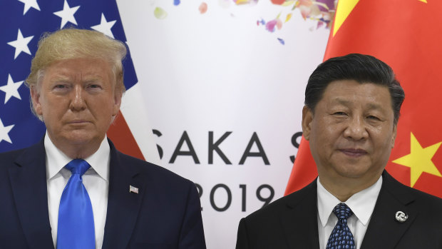 US President Donald Trump, left, poses for a photo with Chinese President Xi Jinping during a meeting on the sidelines of the G-20 summit in Osaka, Japan.