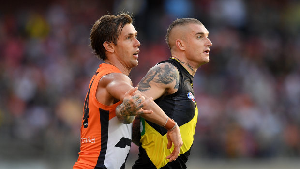Matt de Boer (left), or the "human clamp" as his teammates know him, on Dustin Martin earlier this year.