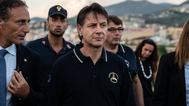 Giuseppe Conte, Italy's prime minister, centre, arrives at the site of the collapsed Morandi motorway bridge in Genoa.