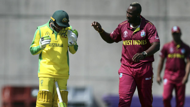 Short and sharp: West Indies' Andre Russell (right) checks on Australia's Usman Khawaja (left) after hitting him on the head with a bouncer during a World Cup warm-up match.
