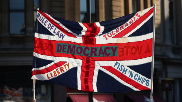 Still disquiet about the looming break from the EU: A British Union flag is held aloft bearing slogans including "Democracy", "Rule of Law", "Liberty", "Tolerance" and "Fish 'n' Chips", during the People's Vote March, in London at the weekend. 