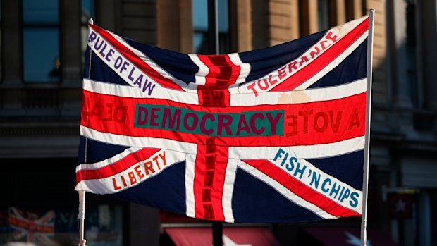 Still disquiet about the looming break from the EU: A British Union flag is held aloft bearing slogans including "Democracy", "Rule of Law", "Liberty", "Tolerance" and "Fish 'n' Chips", during the People's Vote March, in London at the weekend. 