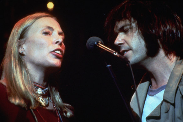 Joni Mitchell and Neil Young performing with The Band.