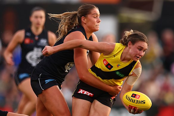 Beth Lynch looks to get her handball away against the rampant Blues.