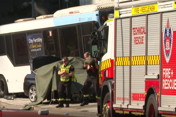 A woman in her 40s has died after a bus and a car collided in Sydney’s west.