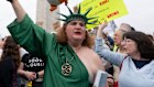 A demonstrator dressed as the Statue of Liberty takes part in the “Hands Off!” protests against President Donald Trump at the Washington Monument. 