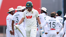 Pat Cummins walks off against Bangladesh.
