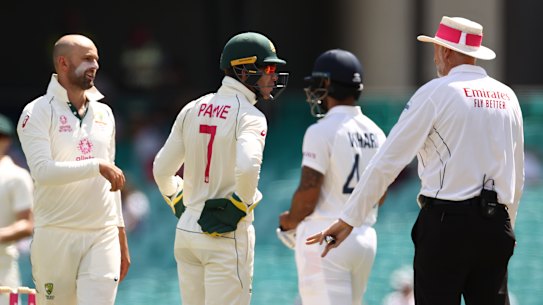 Nathan Lyon and Tim Paine question umpire Paul Wilson over a DRS referral against Cheteshwar Pujara. The spinner will be a key figure on the last day of the SCG Test.