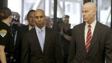 Former Minneapolis police officer Mohamed Noor walks through the skyway with his attorney Thomas Plunkett, right, on the way to court.