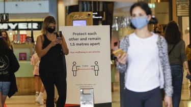 Shoppers wear masks in Sydney on Sunday.