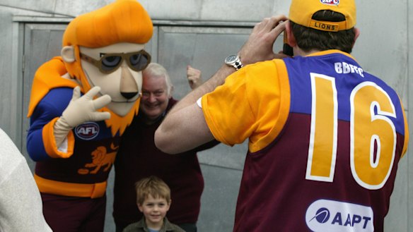 Lions' den: Fans pose for a picture with the Brisbane mascot.