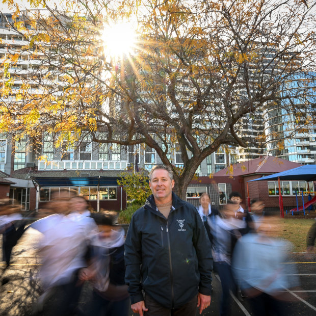  St Monica’s Primary School principal Nathan Owen and students underneath their ‘friendship tree’.