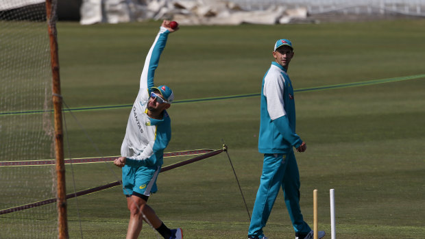 Nathan Lyon bowls as Ashton Agar watches on at training in Rawalpindi. 