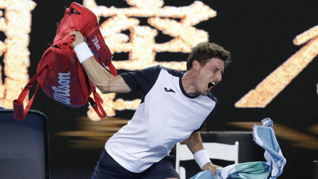 Spain's Pablo Carreno Busta throws his bag in frustration after losing his fourth round match to Japan's Kei Nishikori.