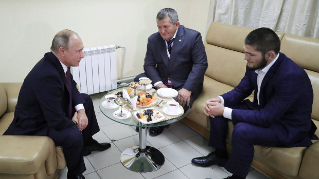 Comrades: Russian President Vladimir Putin (left) meets with Nurmagomedov (right) in Russia.