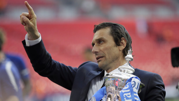 Out the door: Antonio Conte holds the trophy after Chelsea won the FA Cup final against Manchester United in May .