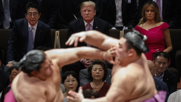 US President Donald Trump watches sumo wrestling with Japanese Prime Minister Shinzo Abe and US first lady Melania Trump.