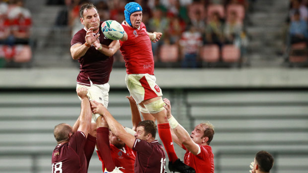 Giorgi Nemsadze of Georgia and Justin Tipuric of Wales compete for a line out ball.