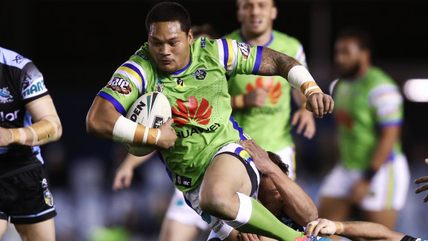 Joseph Leilua of the Raiders is tackled by the Sharks defence during the Round 19 NRL match against the Sharks.