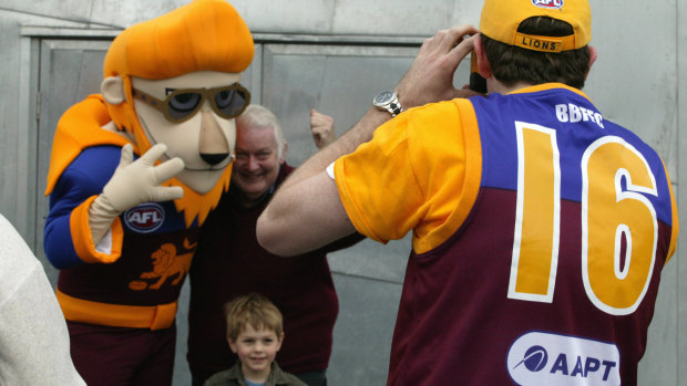 Lions' den: Fans pose for a picture with the Brisbane mascot.