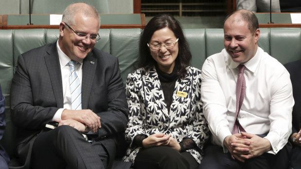 Liberal Gladys Liu is flanked by Prime Minister Scott Morrison and Treasurer Josh Frydenberg during a division in the House of Representatives.