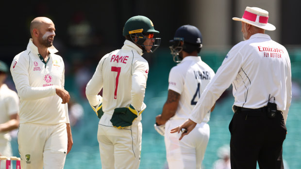 Nathan Lyon and Tim Paine question umpire Paul Wilson over a DRS referral against Cheteshwar Pujara. The spinner will be a key figure on the last day of the SCG Test.