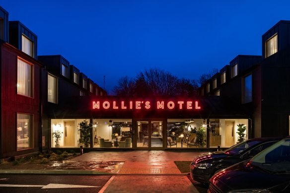 Guests at the Oxfordshire location are greeted by neon red signage and electric vehicle chargers.