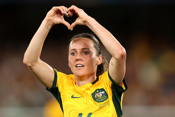 Hayley Raso makes a heart sign as the Matildas score against Uzbekistan.