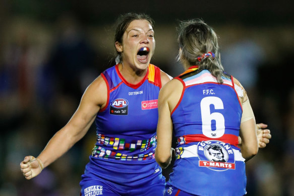 Ellie Blackburn and Kirsten McLeod celebrate as the final siren sounds on their win over the Blues.