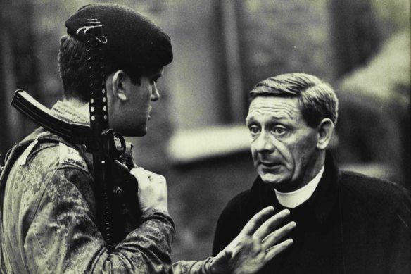 September 1969: a British soldier in Belfast argues with a priest as barbed wire is put up in Dover Street after the riots of the previous month.
