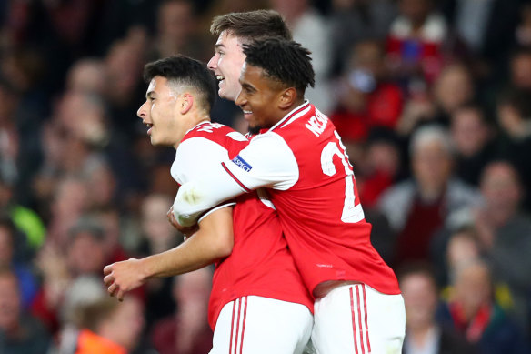 Arsenal's Gabriel Martinelli (left) celebrates with teammates Reiss Nelson and Kieran Tierney in the Europa League.