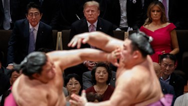 Trump watches sumo wrestling with Japanese Prime Minister Shinzo Abe and first lady Melania Trump.