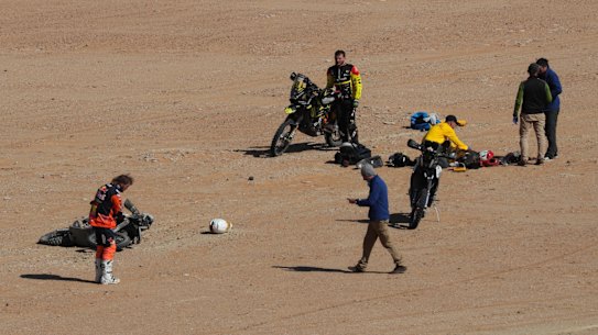 Australian Toby Price (left) at the scene of the Dakar Rally crash which claimed the life of fellow motorbike rider Paulo Goncalves.
