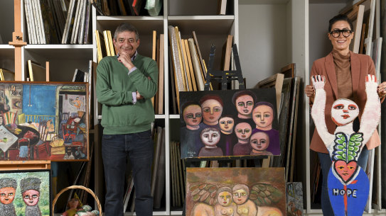 Humanity and hope: William Mora, left, with Jewish Museum of Australia CEO Jessica Bram at Mirka Mora's Richmond studio with some of Mirka Mora's art.