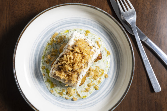 Butter-poached cod fillet topped with  beer-batter bits.