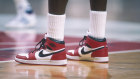 Michael Jordan dons a pair of Air Jordan 1s during a 1985 NBA match against the Bullets in Washington.