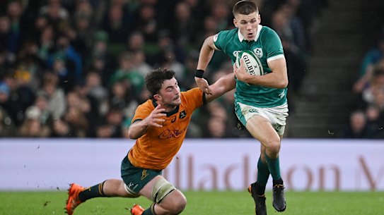 Sam Prendergast of Ireland breaks away from Jeremy Williams of Australia.