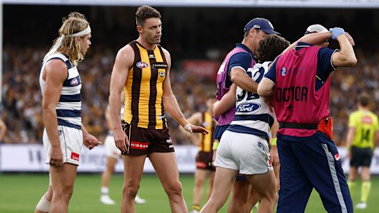 Helped from the field: Gryan Miers requires assistance after he was hit in the head by Conor Nash. The Irish Hawk has been reported.