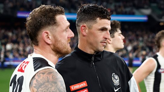 All over: Tim Membrey is consoled by teammate Scott Pendlebury on Friday night.