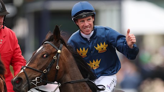 John Allen celebrates after riding Strictly Business to victory in the Oaks. 