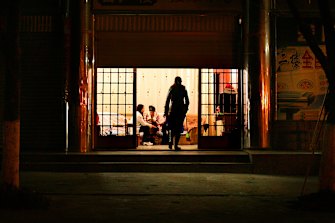 Women sit on couches in the several  brothels which are disguised as hairdressing salons in the Chinese bordertown of Ruili in north-western Yunnan. 