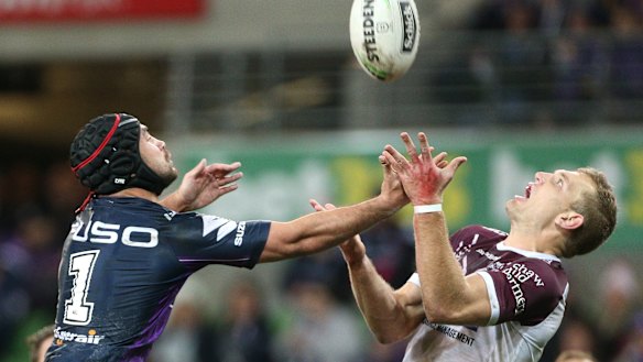 Jahrome Hughes of the Storm (left) contests with Tom Trbojevic of the Sea Eagles.