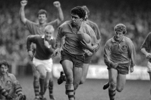 Mark Ella races away to score against Wales in Cardiff.