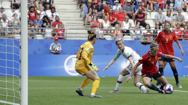 Goal-mouth scramble: Spain's Irene Paredes, right, defends against Rapinoe.