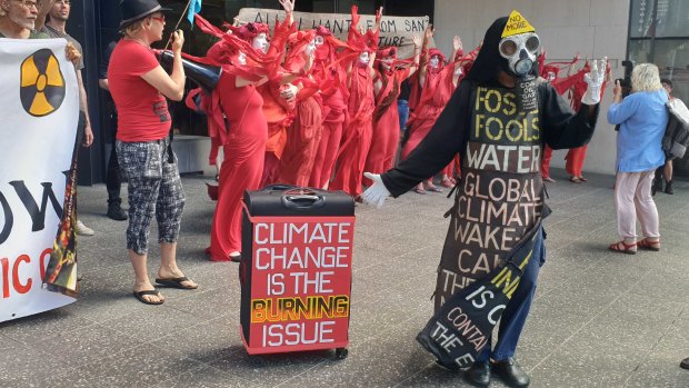 Extinction Rebellion activists were protesting outside of the Santos building in Brisbane on Tuesday, October 8 in Queensland.