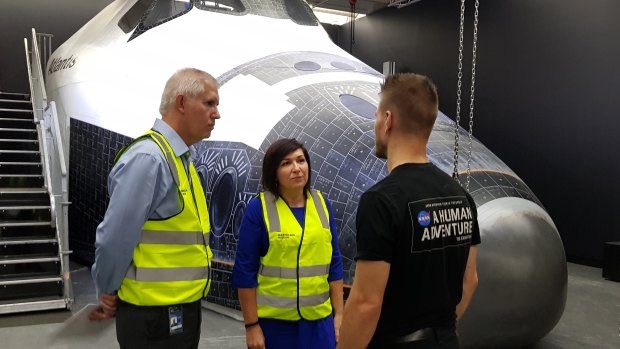 Queensland Museum Network CEO Jim Thompson and Queensland Science Minister Leeanne Enoch speak to 'NASA - A Human Adventure' organiser Jukka Nurminen in front of the full-sized Space Shuttle replica.